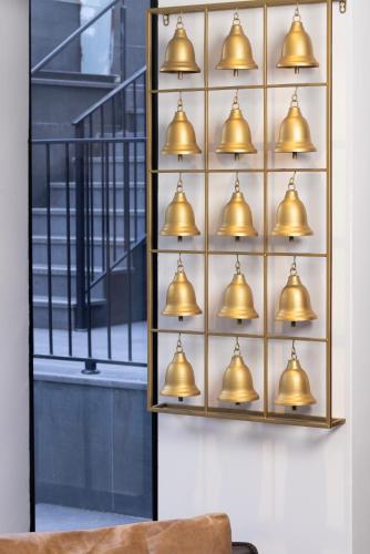 a bunch of bells hanging on a wall at מלון בוטיק H34 in Nahariyya