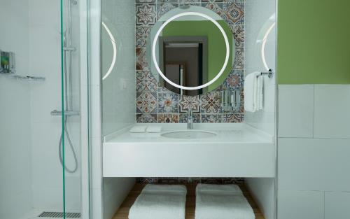 a bathroom with a sink and a mirror at Hampton By Hilton Turkistan in Türkistan