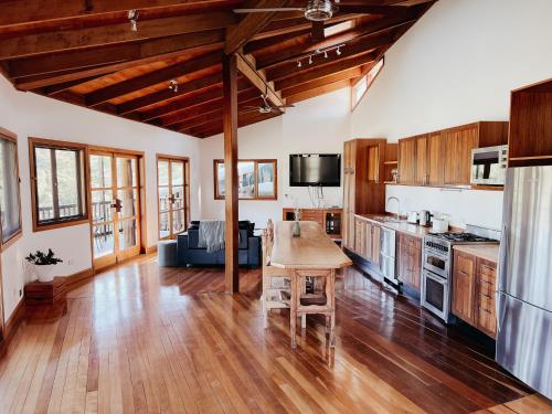 a kitchen with wooden floors and a wooden table at Bellingdale Farm in Clothiers Creek