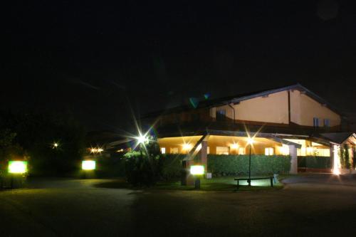 a house lit up at night with lights at Hotel Don Carlo in Broni