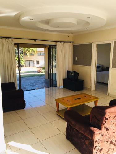 a living room with a couch and a coffee table at Platinum Villa Guest House in Nhlangano