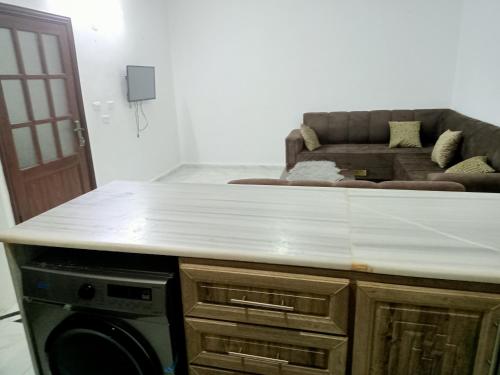 a white counter top in a living room with a couch at رأس منيف /عجلون in Ajloun