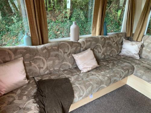 a couch sitting in a room with windows at Kingsgate 49 in Shanklin