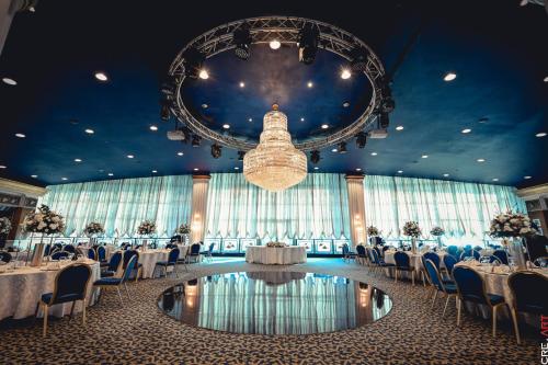 a banquet hall with tables and chairs and a chandelier at Le Royal Hotel - Beirut in Beirut