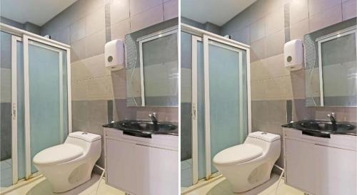 a bathroom with two toilets and two sinks at Villa Tomasa Beach Resort Panglao in Panglao