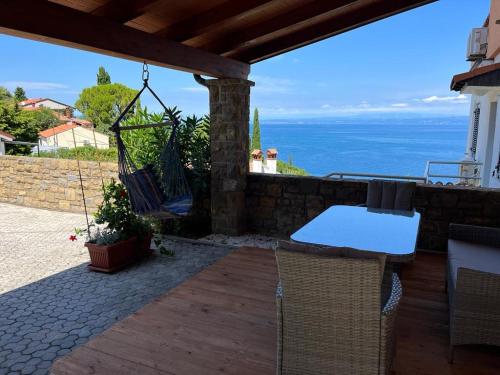 a patio with a hammock and a table and chairs at Apartment Emma in Piran