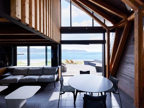 a living room with a couch and a table at CAP MARTIN Funny house in Kyonan