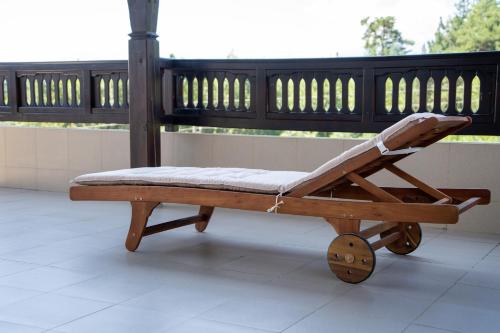 a wooden chair sitting on top of a porch at Rusaliite Adventure House in Bachevo