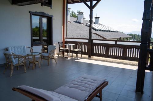 a balcony with a table and chairs and a table and chairs at Rusaliite Adventure House in Bachevo