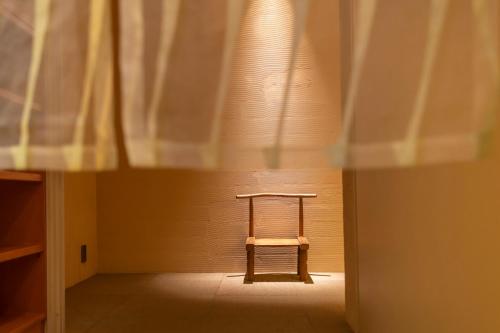 a small wooden table in a room with a window at River Retreat Garaku in Toyama