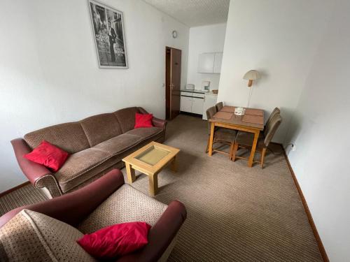 a living room with a couch and a table at "Altes Haus" am Kurpark in den Bergen in Zorge