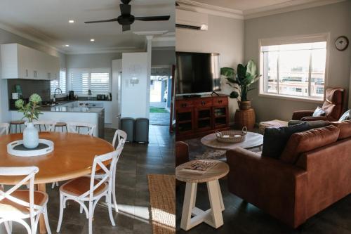 a living room and kitchen with a couch and a table at On The Sand at Mollymook Beach in Mollymook