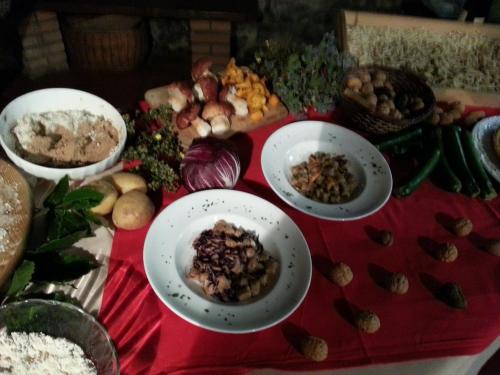 a table with plates of food on a red table at Agriturismo Al Marnich in Schignano