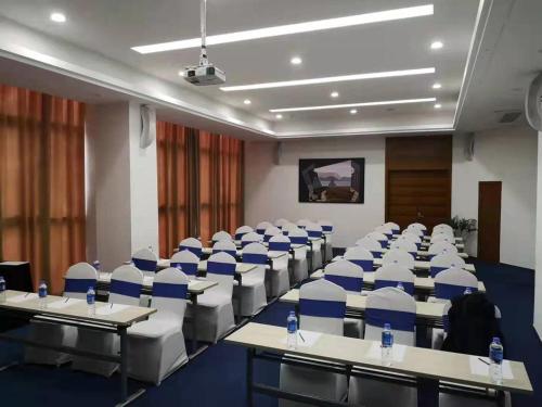 a room with rows of tables and chairs at Holiday Inn Express Suzhou Changjiang by IHG in Suzhou