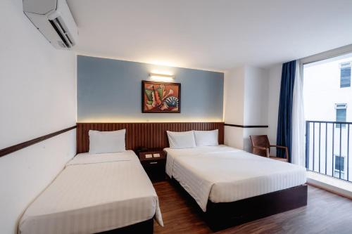 Ένα ή περισσότερα κρεβάτια σε δωμάτιο στο King Hotel