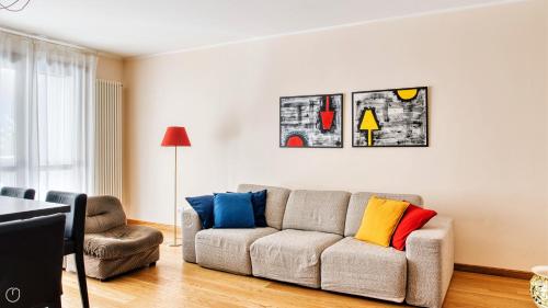 a living room with a couch with colorful pillows at Italianway Comfort - Salasco 18 in Milan
