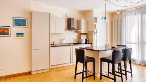 a kitchen with a table and chairs in a room at Italianway Comfort - Salasco 18 in Milan