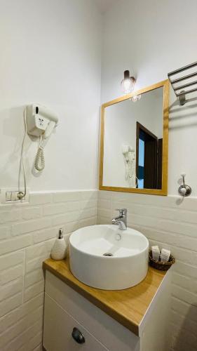 a bathroom with a white sink and a mirror at EPIC HOUSE Valea Avrigului in Avrig