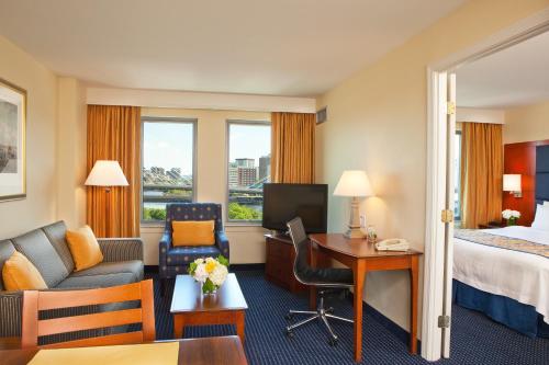 a hotel room with a bed and a desk and a couch at Residence Inn by Marriott Boston Harbor on Tudor Wharf in Boston