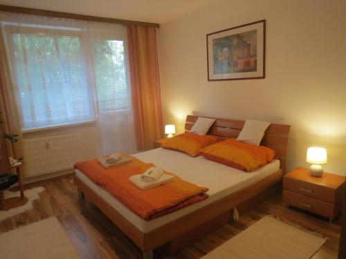 a bedroom with a bed with two towels on it at Apartman Classic in Komárno