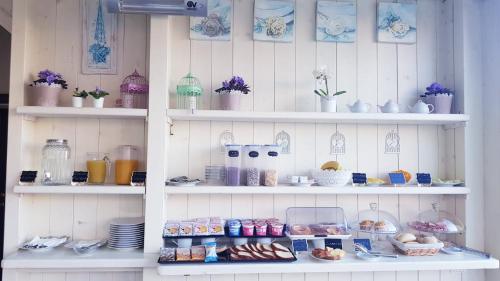 a shelf with food and other items on it at Contessa Arrivabene Antica Dimora in Rome