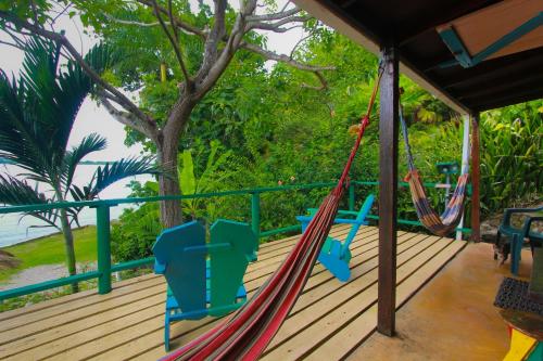 a hammock on the deck of a house at Zion Country in Manchioneal