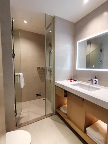 a bathroom with a shower and a sink at Keypai Hotel Free Shuttle Bus to Canton Fair in Guangzhou