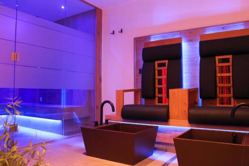 a stage with purple lights in a room at Aida Apart in Nauders