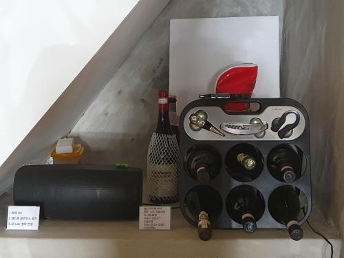 a box with a bottle of wine and a tool at Yachtie Inn Mokpo in Mokpo