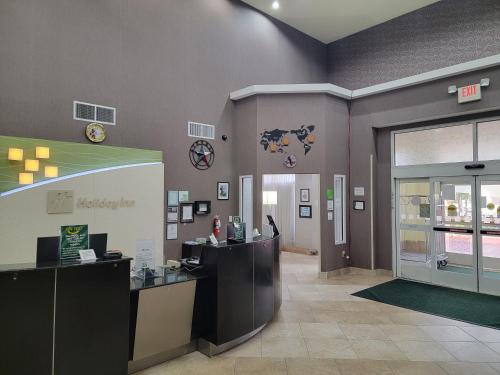 a lobby of a store with a reception desk at Holiday Inn Garland by IHG in Garland