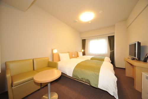 Posteľ alebo postele v izbe v ubytovaní Dormy Inn Obihiro