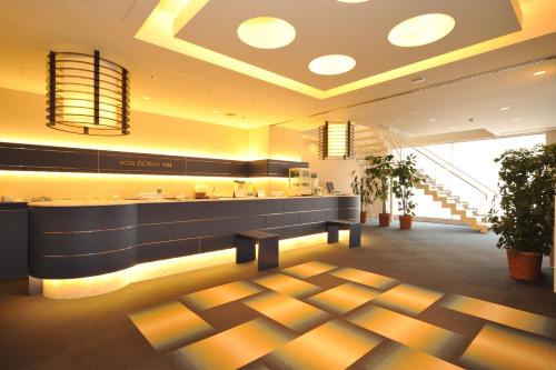 a lobby of a hotel with a reception desk at Dormy Inn Obihiro in Obihiro