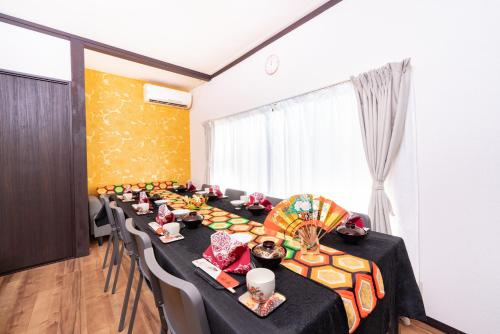 a conference room with a long table with black table cloth at 6BR 10Beds Direct to Shinjuku, Shibuya ,Tokyo Dome, Central ,Budget Friendly in Tokyo