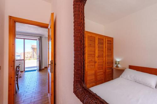 a bedroom with a mirror next to a bed at La casa di Gio in Isola Rossa