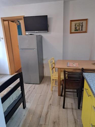 a small kitchen with a table and a refrigerator at Lighthouse in Vodice