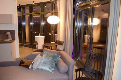 a living room with a couch and a large window at Hotel im Bunker in Munich