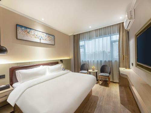 Postel nebo postele na pokoji v ubytování Gya Hotel Suzhou Hanshan Temple Binhe Road