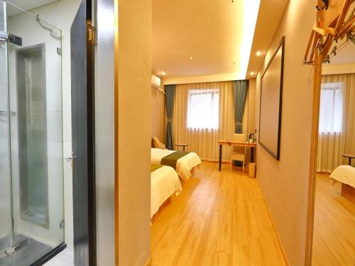 a hotel room with two beds and a room with a room at GreenTree Inn Express Hotel North Huaihai Road in Huai'an