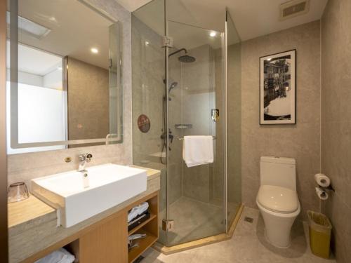 a bathroom with a sink and a shower and a toilet at GreenTree Eastern Hotel Lihu Yuantouzhu Scenic Area in Wuxi
