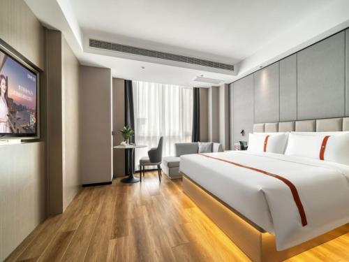 Ένα ή περισσότερα κρεβάτια σε δωμάτιο στο GreenTree Eastern Hotel Jiangsu Wanda Plaza Ocean University Huangguoshan
