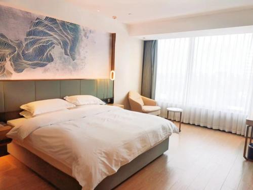 Ένα ή περισσότερα κρεβάτια σε δωμάτιο στο GreenTree Eastern Hotel Jiangsu Wanda Plaza Ocean University Huangguoshan