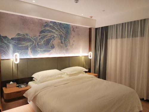 Ένα ή περισσότερα κρεβάτια σε δωμάτιο στο GreenTree Eastern Hotel Jiangsu Wanda Plaza Ocean University Huangguoshan