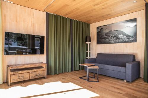 a living room with a couch and a table at Hotel Arlmont 4 Stern Superior in Sankt Anton am Arlberg