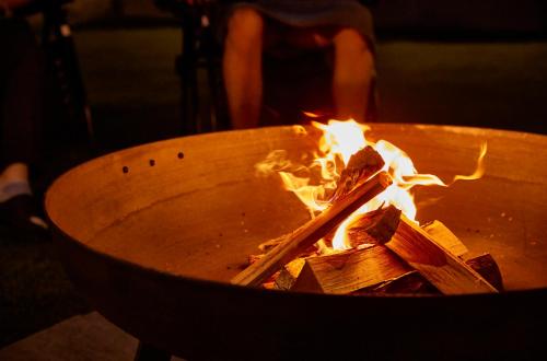 a fire in a pot with some wood in it at Resoreat Takashima in Imazu