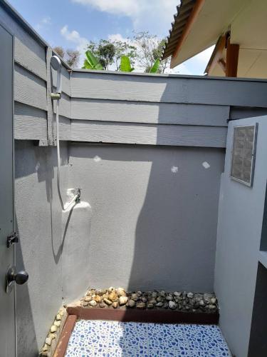 a door with a pebble walkway next to a wall at Khaolak Banana Bungalow in Khao Lak