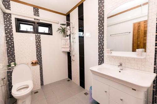 łazienka z toaletą i umywalką w obiekcie Sichon Pool Villa - สิชลพูลวิลล่า 