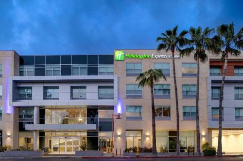 an exterior view of a building with palm trees at Holiday Inn Express & Suites - Glendale Downtown in Glendale
