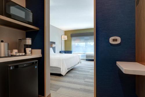 a view of a room with a bed and a bathroom at Holiday Inn Express & Suites - Glendale Downtown in Glendale