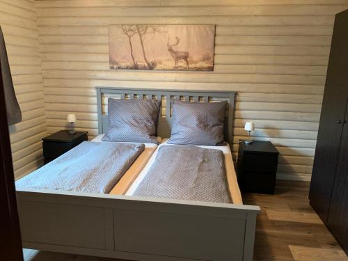 a bedroom with two beds and two night stands at Einfach wohlfühlen, inklusive aktivCard Bayerischer Wald in Arrach