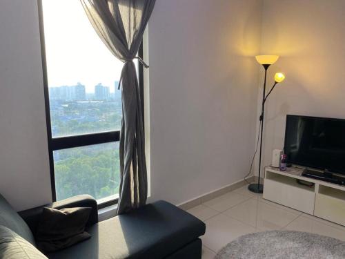a living room with a couch and a large window at Islamic Santai Santai Homestay - Centrus Soho Cyberjaya in Cyberjaya